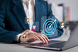 © Pakin - Target customers concept. Audience outreach and sales generation. Businessman using laptop with target customer icons on virtual screen.