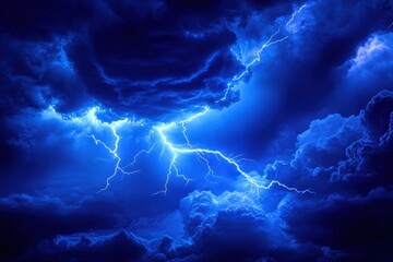 dramatic blue sky with lightning strikes illuminating dark storm clouds creating a powerful natural 