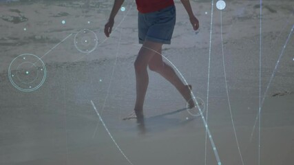 Poster - Person walking on beach with digital network lines overlay animation