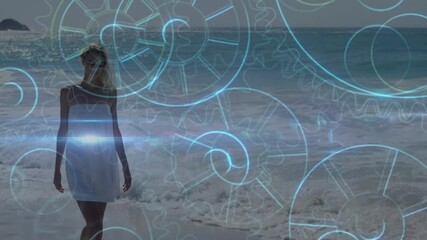 Poster - Walking on beach, woman with animated blue gears overlay in background