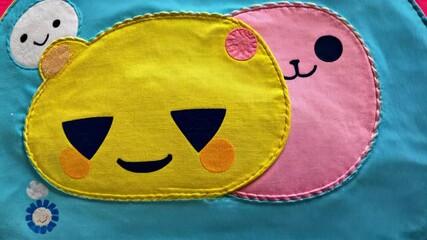 Fototapete - A wall covered in various smiling faces, including one with a blue face in the middle