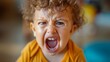 © Emiliia - Emotional toddler expressing frustration and screaming in a playful environment during the day