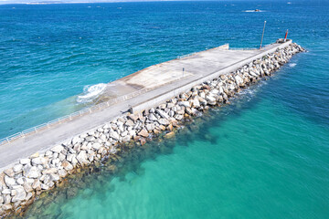 Fototapete - aerial drone view, breakwater on a clear day with calm water