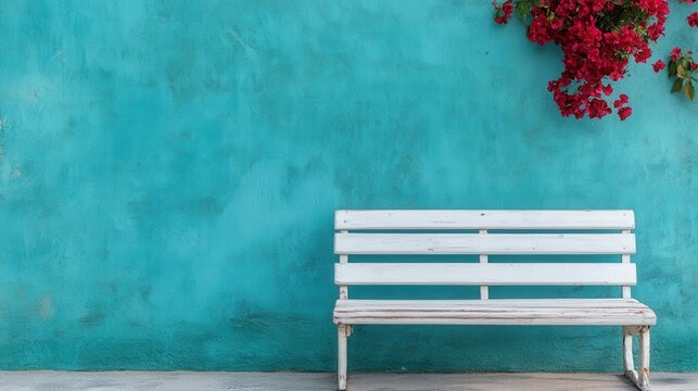 This serene image captures a weathered white bench positioned in front of a dynamic turquoise wall, creating a peaceful atmosphere perfect for relaxation and contemplation.
