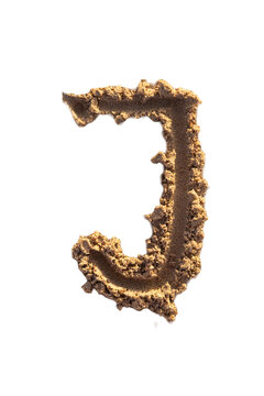 Alphabet (J) letters handwritten in sand on beach