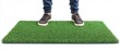 © slowbuzzstudio - Person standing on a green grass floor mat isolated on white background.