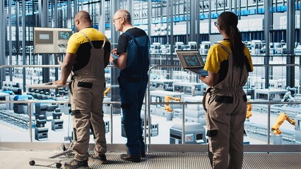 Poster - engineers in industry 4.0 industrial plant controlling automated machinery, ensuring workflow contin