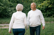 © Максим Галінский - 28.09.24 Vinnitsa, Ukraine: a nice couple of grandparents who look good and pose for a photo in light clothes in front of a park