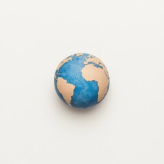 Wall Mural - a small, hand-painted globe showing continents in earthy tones and oceans in blue, set against a pla