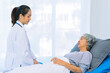 © ArLawKa - Asian female doctor consulting elderly patient at home, explaining diagnosis and treatment plan, providing health care to elderly woman, medical health concept