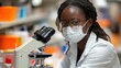© Yana - Focused Scientist Inspecting a Sample with a Microscope in a Lab Setting