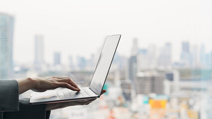 Poster - Woman using a laptop with city background