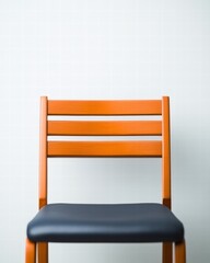 Poster - Simple chair positioned against a wall creating a minimalist aesthetic in a modern indoor space