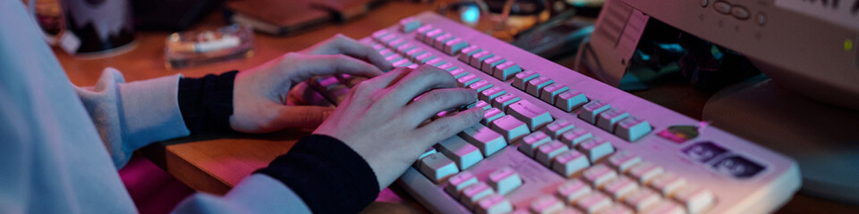 Hands Writing Code on Retro Computer