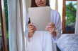 © Farknot Architect - Closeup image of a woman holding and using digital tablet at home