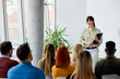 © bnenin - Speaker Engaging an Audience During a Training Session in a Modern Office Space
