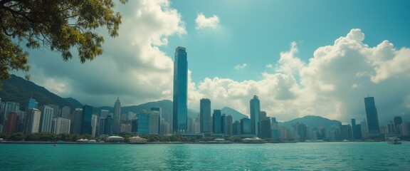Aufkleber - Panoramic view of a cityscape skyline with tall buildings against a partly cloudy sky, surrounded by mountains and blue water.