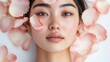 © BlackLion - Close-up portrait of a young woman with rose petals on her face in a serene setting