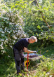 © Johnér - Mature man working in garden with tool
