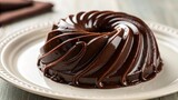 A chocolate pudding dessert on a white plate, showcasing a sweet treat.
