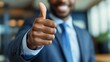 © 99 RIC - Confident african american businessman giving thumbs up gesture close up