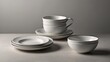 © Nathan - Minimalist white dinnerware set featuring plates, bowls, and a cup, showcasing elegant ribbed designs against a soft gray backdrop.
