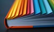 © NovaVision - A close-up showcases a vibrant book's rainbow pages, creating a colorful spectrum of knowledge.