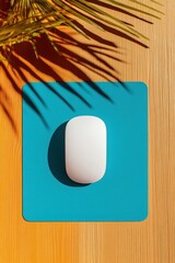 Poster - Minimalist Tech Serenity Ergonomic White Mouse on Vibrant Teal Pad with Tropical Shadow Play - Contemporary Workspace Inspiration for Digital Professionals