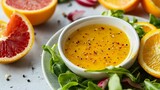Orange vinaigrette dressing with tiny pulp particles visible, elegantly plated with citrus slices