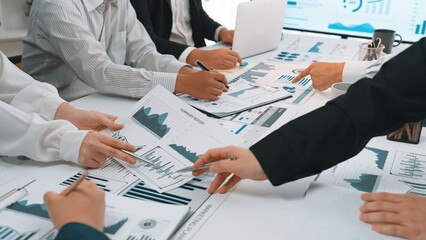 Poster - a diverse team engages in a collaborative business meeting, analyzing various graphs and charts to e