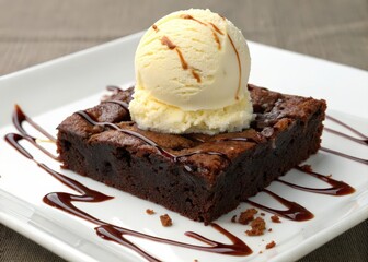 Poster -  Rich brown chocolate cake on white plate with vanilla ice cream and drizzle of caramel sauce. 