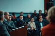 © Volodymur - Press conference with politician speaking at podium in front of audience