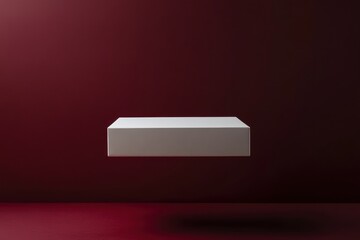 Poster - Minimalist floating white box presented against a dark red background showcasing modern design aesthetics