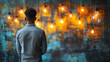 © Collorio - Black man standing with back turned facing illuminated light bulbs against artistic wall, creativity and inspiration concept