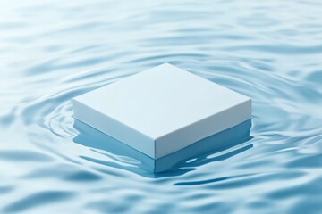 Poster - Floating white box on calm blue water creating a serene and minimalist atmosphere at midday