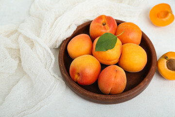 Wall Mural - plate with fresh apricots on white table