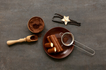 Wall Mural - plate with curd bars and powdered coffee on black grunge background