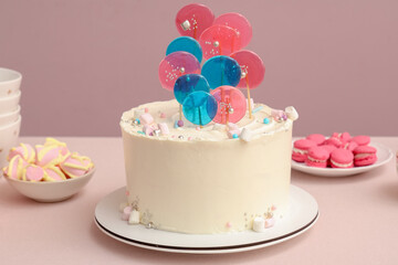 Wall Mural - cake with sweets for birthday party on table against pink wall
