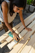 © Luis Herrera/Stocksy - woman DIY sanding machine