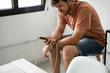 © Alba Vitta Studio/Stocksy - Man charging phone