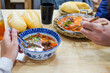© Studio KME/Stocksy - Two People Sharing a Vietnamese Meal