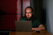© Studio KME/Stocksy - Focused Man Working Late on Laptop