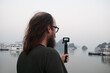 © Studio KME/Stocksy - Bearded Man Filming with action camera in Ha Long Bay