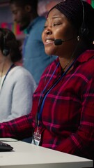 Poster - Vertical video Customer center employee gesturing loud colleague to quiet down during conversation with client. Call center worker upset by noises in office while talking to customers using headphones