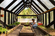 © Luis Herrera/Stocksy - Woman working inside a greenhouse