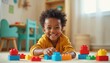 © miss irine - Happy African American boy plays with colorful building blocks in nursery room. Smiling child enjoys playtime. Kid builds structure from toy blocks at home. Childhood fun and creativity.