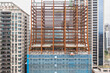 © Lawren Lu/Stocksy - Urban Construction of Steel Structure Among High-Rises Buildings