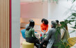 © VICTOR TORRES/Stocksy - Diverse group engaged in casual office meeting discussion