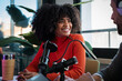 © VICTOR TORRES/Stocksy - Friendly podcast conversation in modern studio setting