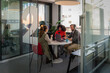 © VICTOR TORRES/Stocksy - Collaborative podcast in a modern glass-walled office space